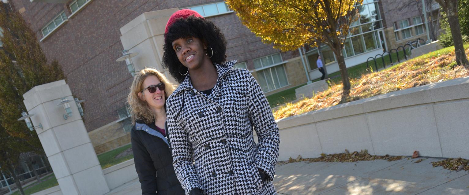 An instructor teaching student long cane use
