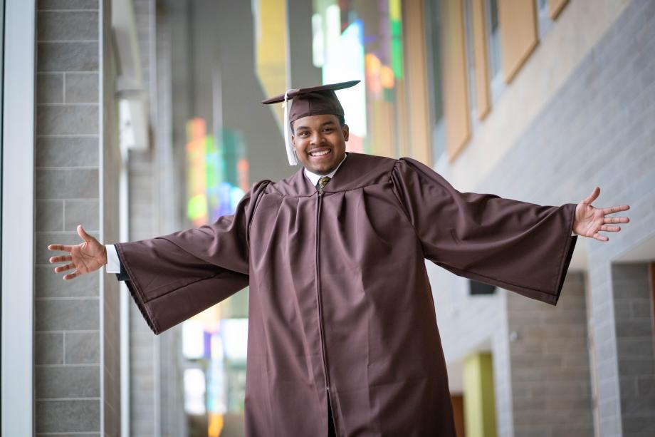 Asa Hollingsworth poses for a photo in his graduation regalia.