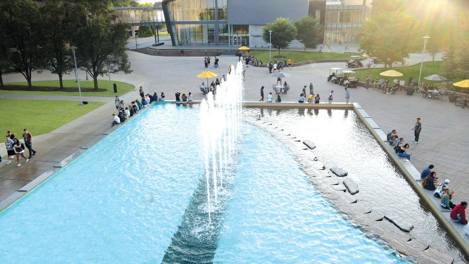 A drone of the fountain, with students.