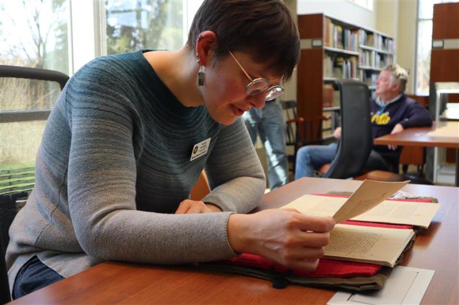 Person looking at materials at a table in the Zhang Legacy Collections Center reading room.