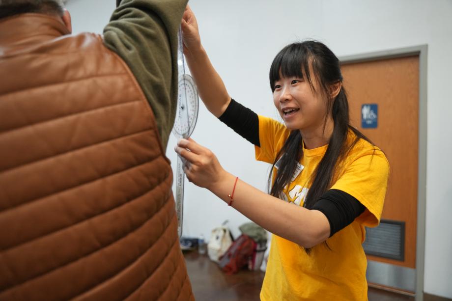 A student measure range of motion on a patient.