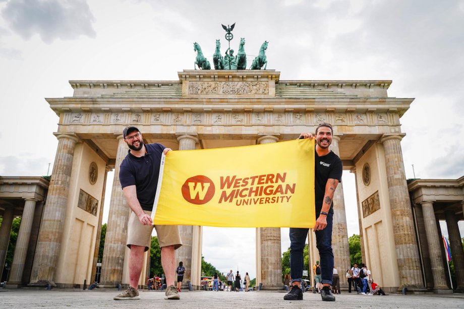 WMU students are seen holding the WMU flag in Berlin.