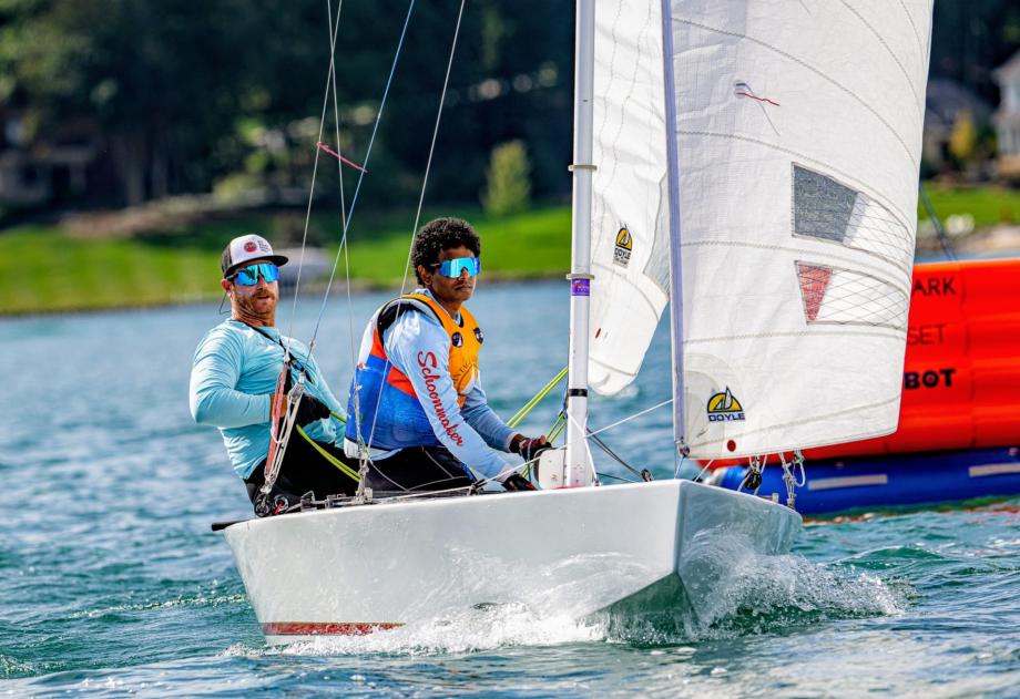 Two people on a vintage sail boat.