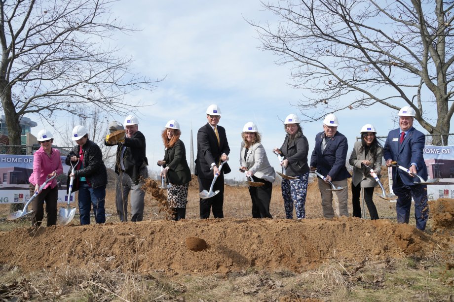 A group of WMU stakeholders tosses dirt into the air during the groundbreaking for the new Michigan Geological Repository for Research and Education on the WMU Parkview Campus.