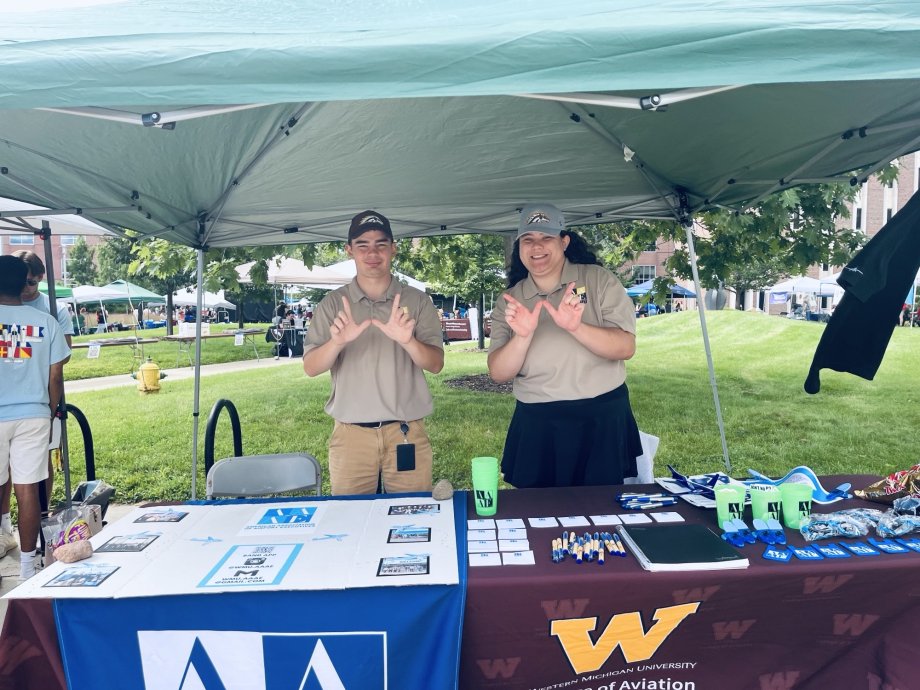 Two students at bronco bash representing AAAE.