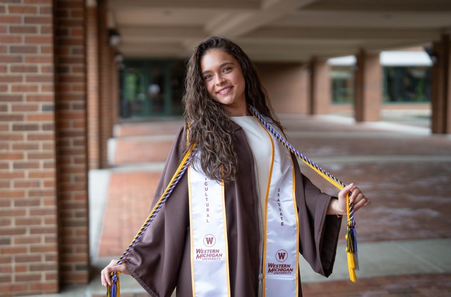 Jadazay Ledbetter celebrates in her graduation regalia.