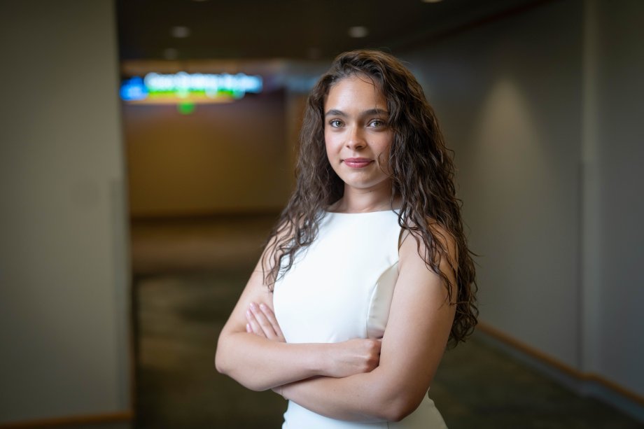 Jadazay Ledbetter stands with her arms crossed in the hallway of Schneider Hall.