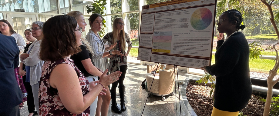 Health Admin students presenting research posters.