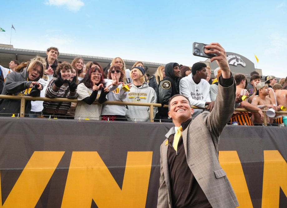President Russ Kavalhuna takes a selfie with students in the stands at Waldo Stadium.