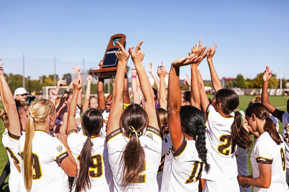WMU's women's soccer team hoists their MAC championship trophy.