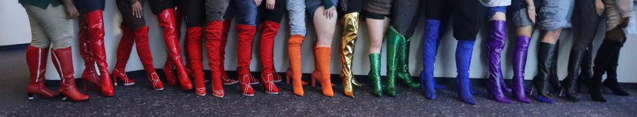 A row of rainbow colored high heeled boots