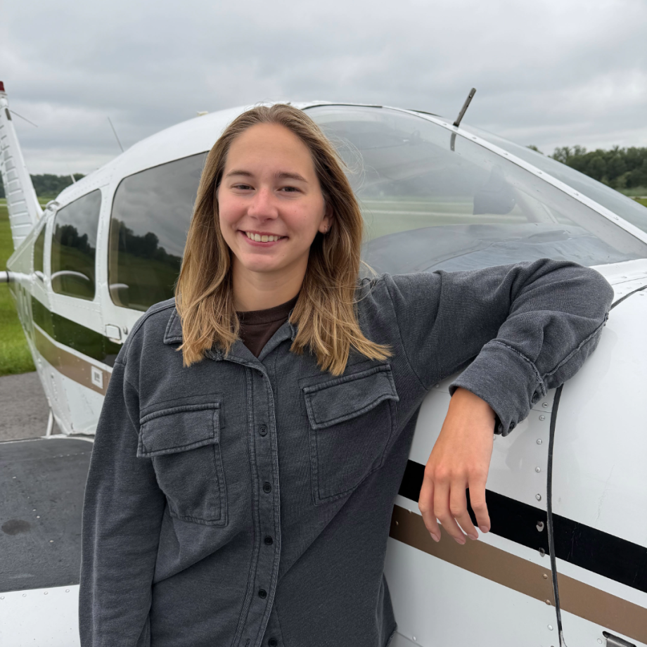 Student in front of plane.