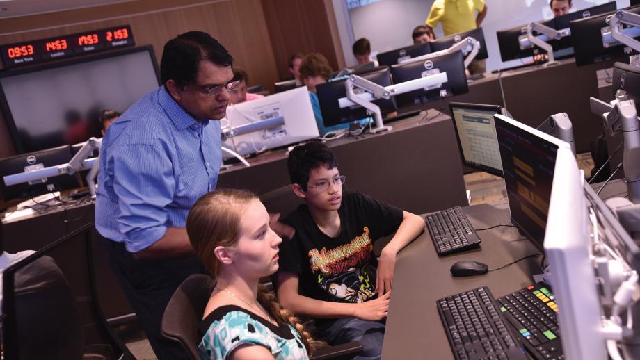 Instructor and camp participants looking at computer screens