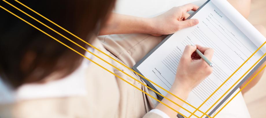 doctor writing on a medical form