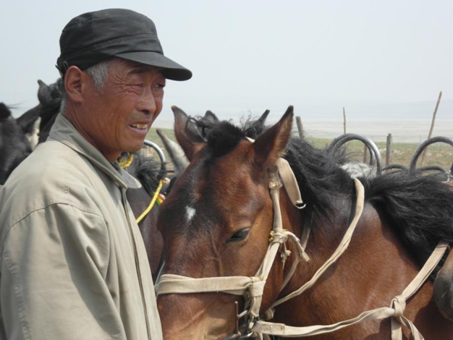 Man and horse in Inner Mongolia, China.