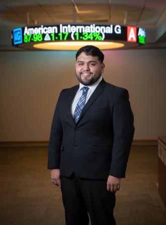 A portrait of Jesus Osvaldo Martinez-Jimenez in a business suit.
