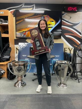 Ariana Burgeson holds the hockey national championship trophy.