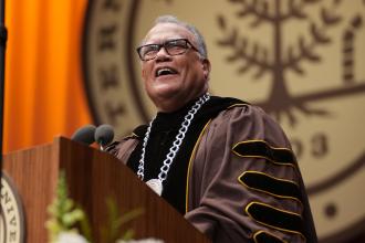 President Edward Montgomery at the podium at commencement.