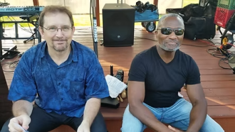 Tony and Doug sitting on a stage