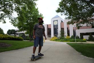Yoyo Rodriguez-Vargas skateboards through campus.