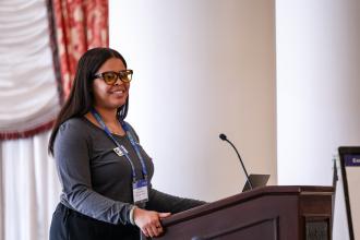 Brianna Hooks Singletary standing at a podium giving a presentation
