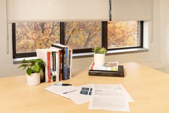 Evaluation themed resources displayed on a desk with a window in the background