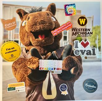 Buster Bronco holding WMU Evaluation Center themed stickers