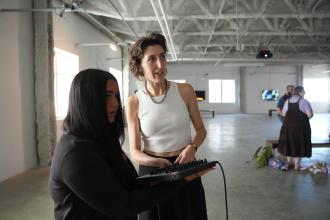 An artist talks to a student.