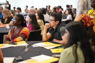 International students gather at tables for sessions during International Student Orientation.