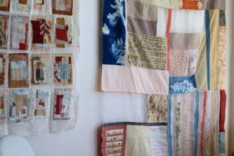 Textile artwork made with natural dyes from the found environment hanging on a wall. 