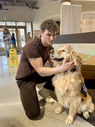 Travis Melson with a therapy dog.
