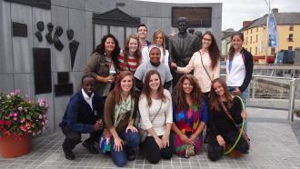Akol in front of statue