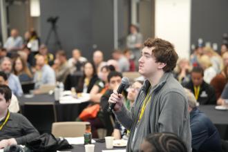 A student talks into a microphone.