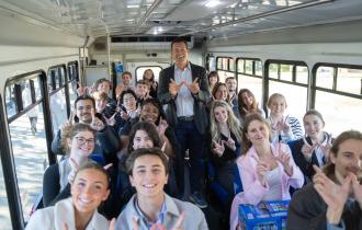 Dr. Doug Lepisto and students inside a bus.