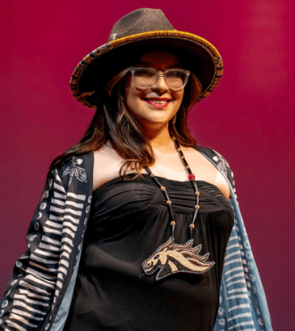Student modeling in the IndigiJam fashion show, hosted by WMU's Native American Student Organization