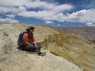 man sitting on nepal cliff 