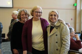 Teacher Terri Bieszka, center, reflected on milestone moments in international education and CELCIS’s enduring contributions at the celebration. She poses here with a student and colleague.