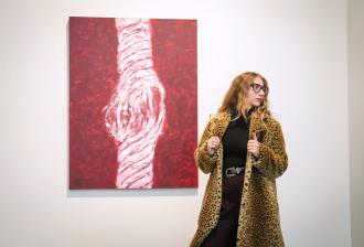 Hope Donovan poses next to a painting.