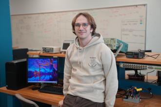 A portrait of Noah Braasch in a computer engineering lab.