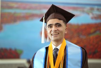 A portrait of Mehran Najafi in his graduation cap and gown.