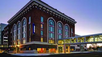 Multi-story building with a bridge entering at the second floor. 