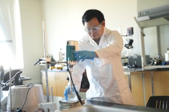 Dr. Jinghao Li at work in a lab. 