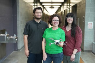 Dr. Ilgin Acar (center) shown with Eren Darici (left) and Kira Hamelink, doctoral students in industrial engineering.