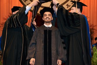Sachin Sharma is given his doctoral hood.