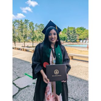 Sutopa Suhrid poses for a picture in her graduation regalia.