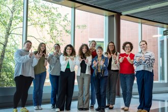 Margean Gladysz (fourth from right) shares her Bronco pride by flashing the W and supporting women in engineering and applied sciences. Shown with students and faculty of the college.