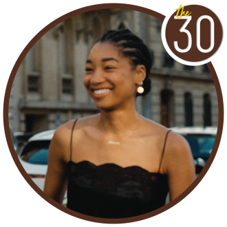 Reagan Baty standing in the middle of the city in a black dress