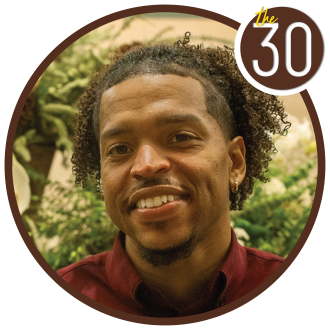 Daniele Gaddy, B.B.A.’17 standing in front of some trees