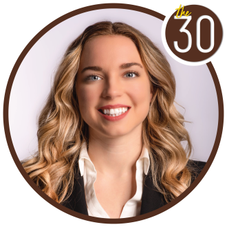 McKayla Marcola, B.B.A.’18 in a suit in front of a white background