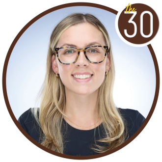 Lexie Wark, B.B.A.’18 in front of a blue background